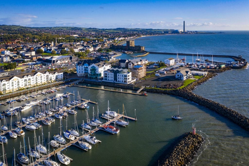 The Norman Carrickfergus Castle and a modern Marina situated at the entrance to Belfast Lough in County Antrim, Northern Ireland